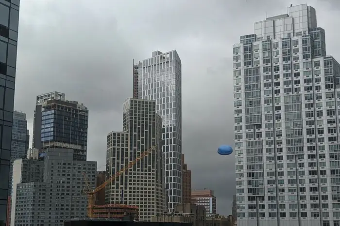 A kiddie pool sent aloft by high tropical storm winds flies among rooftops in downtown Brooklyn.